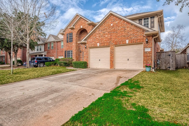 traditional home with brick siding, an attached garage, driveway, and a front yard