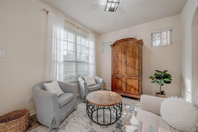 sitting room featuring baseboards and light wood finished floors