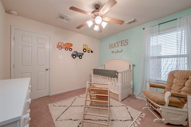 bedroom featuring visible vents, light carpet, and baseboards