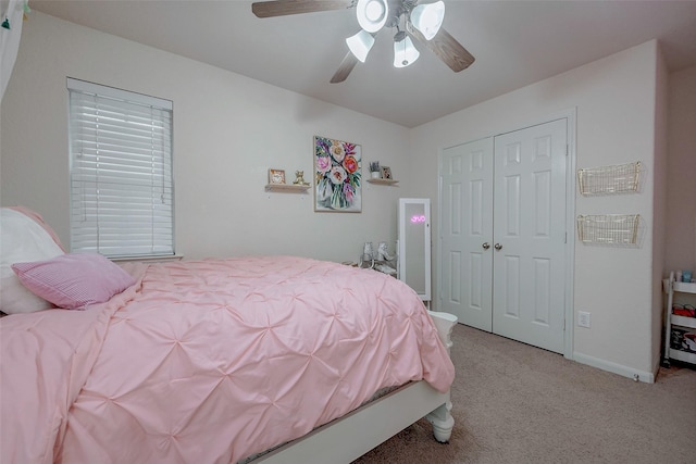 bedroom featuring a closet, ceiling fan, baseboards, and carpet