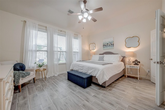 bedroom with wood finish floors, visible vents, baseboards, and a ceiling fan