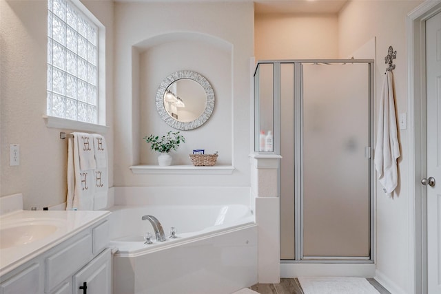 bathroom featuring vanity and shower with separate bathtub