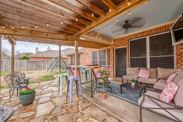 view of patio / terrace featuring ceiling fan, an outdoor hangout area, and a playground