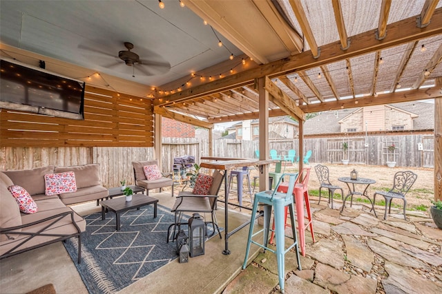 view of patio featuring an outdoor living space, fence, and ceiling fan