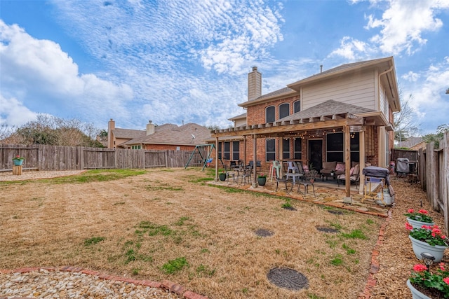 rear view of house featuring a patio and a playground