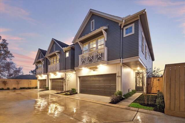 6024 T C Jester Blvd, Houston, TX 77091 - view of front facade with an attached garage, a balcony, fence, and driveway
