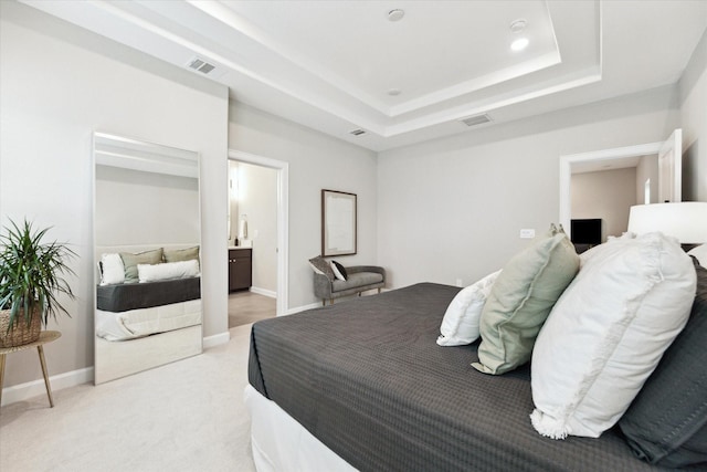 6024 T C Jester Blvd, Houston, TX 77091 - bedroom featuring visible vents, baseboards, a tray ceiling, and light colored carpet