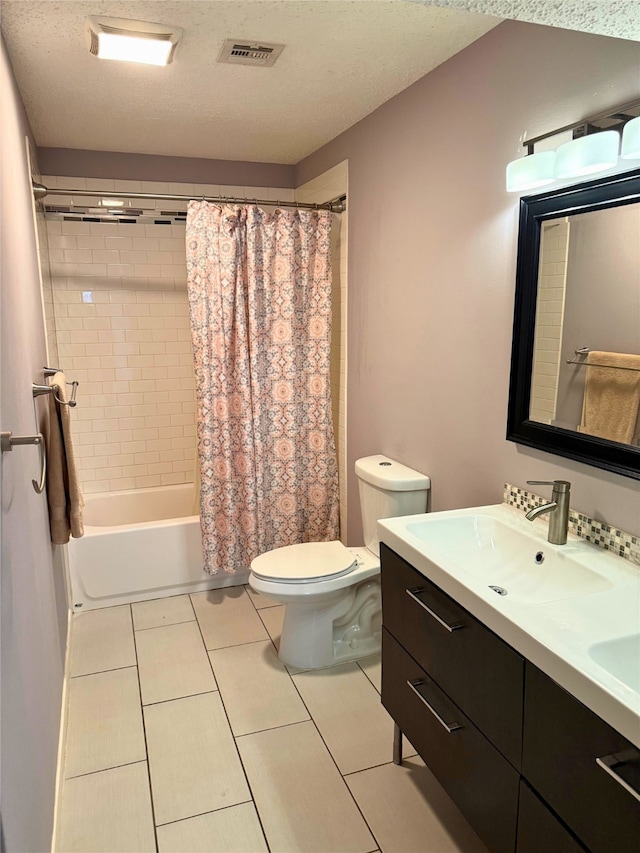 full bathroom featuring vanity, a textured ceiling, toilet, and shower / bath combo