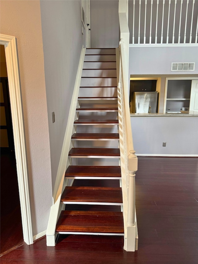 stairway featuring hardwood / wood-style flooring