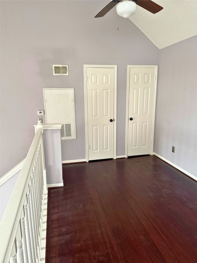 interior space featuring dark wood-type flooring, ceiling fan, and lofted ceiling