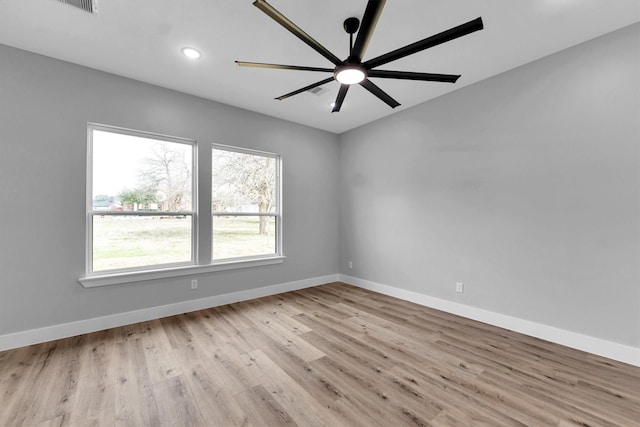 spare room with ceiling fan and light wood-type flooring