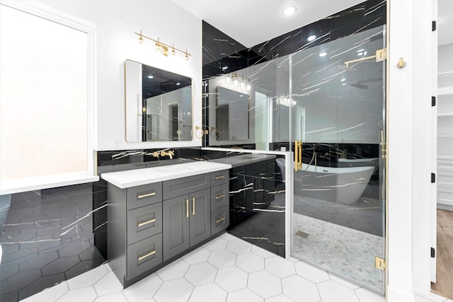 bathroom featuring vanity, shower with separate bathtub, and tile walls