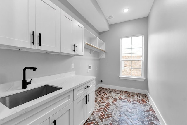 laundry room featuring sink, hookup for a washing machine, cabinets, and hookup for an electric dryer