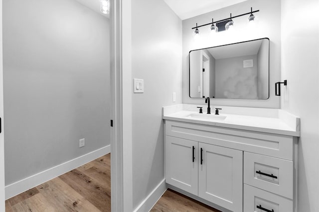 bathroom with vanity and hardwood / wood-style flooring