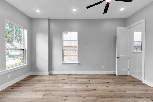 empty room featuring ceiling fan and light wood-type flooring