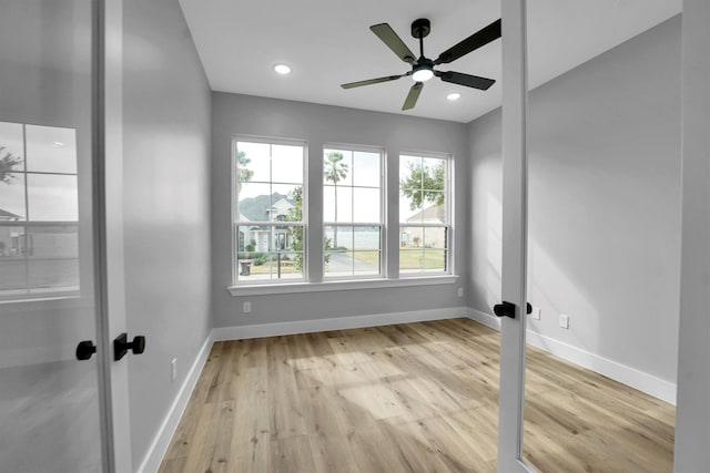 unfurnished room featuring light hardwood / wood-style flooring, french doors, and ceiling fan