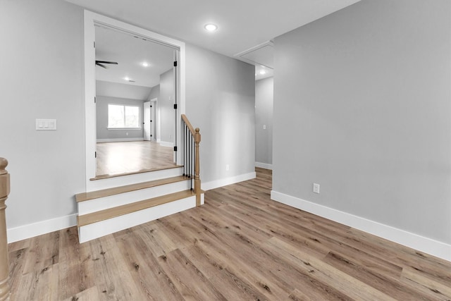 stairway with hardwood / wood-style flooring