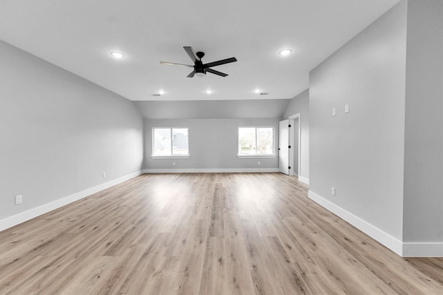 spare room featuring ceiling fan, lofted ceiling, and light hardwood / wood-style floors