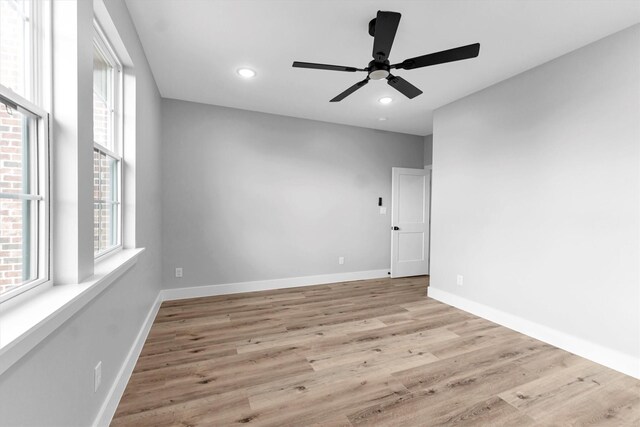 spare room featuring ceiling fan and light wood-type flooring