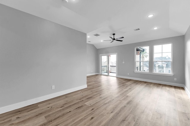 unfurnished room featuring lofted ceiling, light hardwood / wood-style floors, and ceiling fan