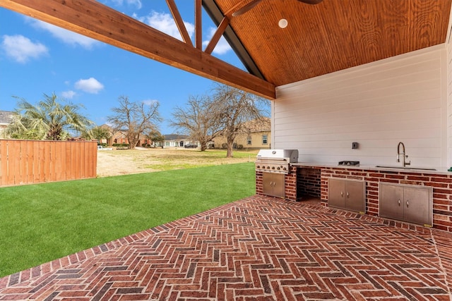 view of patio / terrace featuring exterior kitchen, area for grilling, and sink