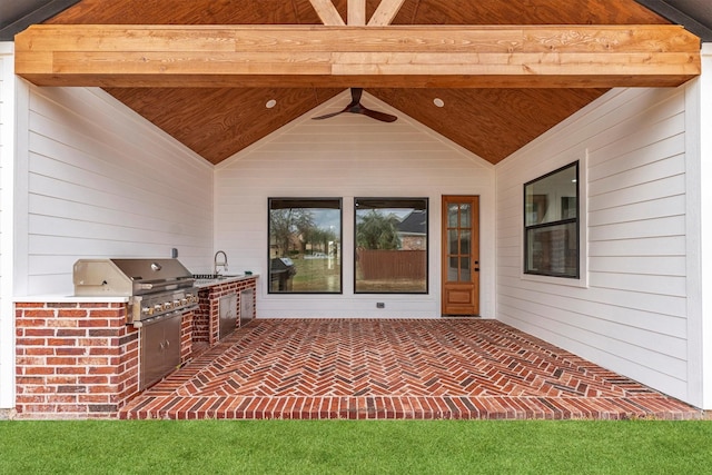 view of patio with area for grilling, a grill, and sink