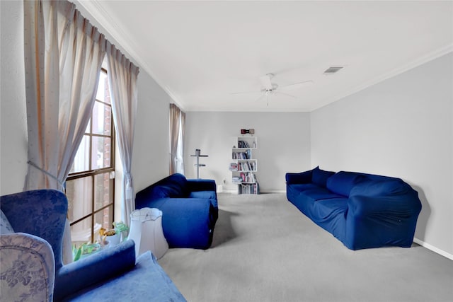 carpeted living room with ornamental molding and ceiling fan