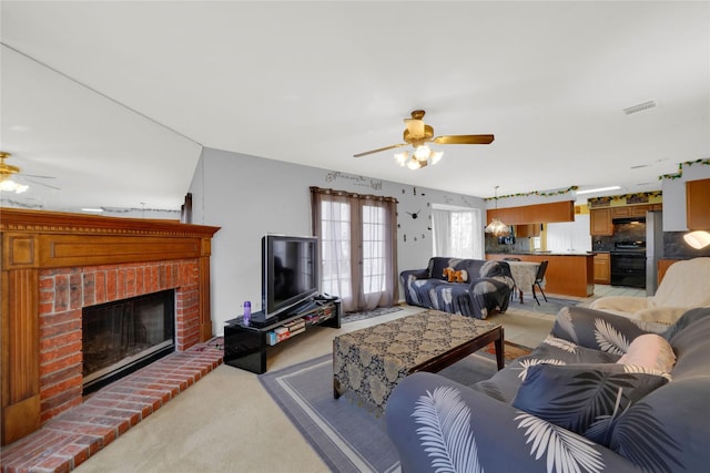 living room featuring light carpet, a fireplace, french doors, and ceiling fan