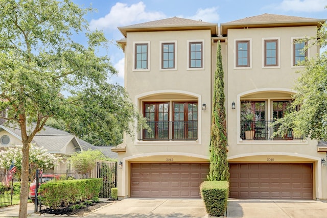 view of front of home with a garage and a balcony