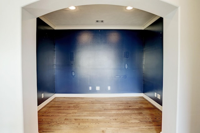 spare room featuring hardwood / wood-style flooring and ornamental molding