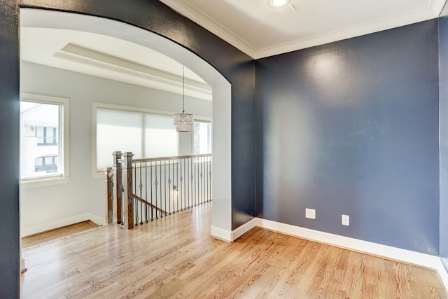 empty room featuring crown molding and light hardwood / wood-style floors