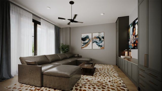 living room with ceiling fan and light wood-type flooring