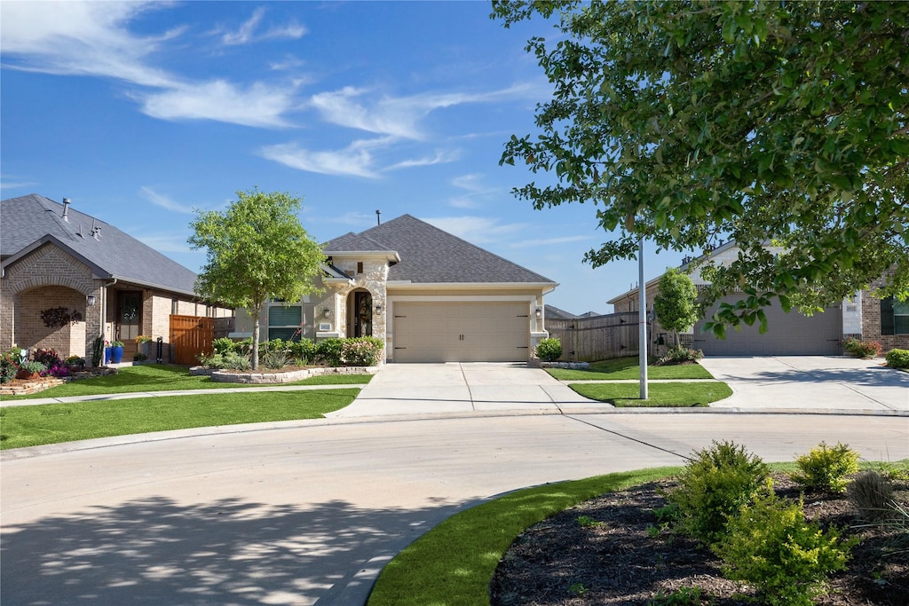 view of front of property featuring a garage and a front lawn