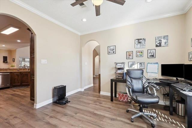 office featuring crown molding, ceiling fan, and light wood-type flooring