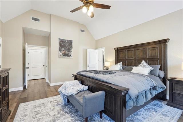 bedroom featuring ceiling fan, dark wood-type flooring, and high vaulted ceiling