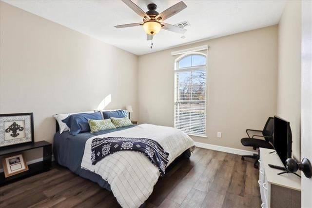 bedroom with ceiling fan and dark hardwood / wood-style flooring