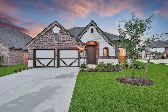 view of front of house with a garage and a lawn