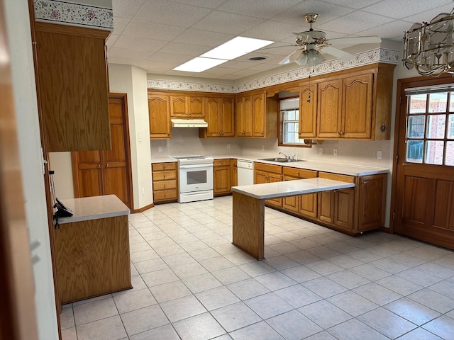 kitchen featuring sink, white appliances, a paneled ceiling, ceiling fan, and kitchen peninsula