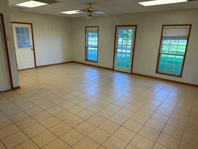 unfurnished room with ceiling fan and a paneled ceiling