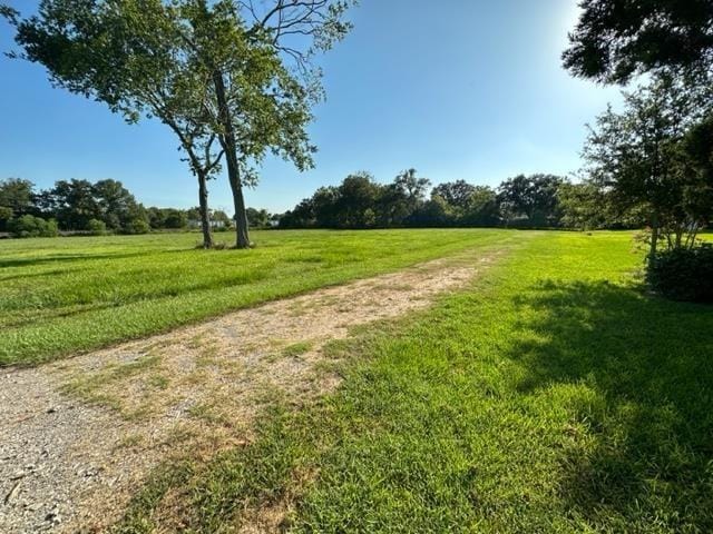 view of community with a yard and a rural view