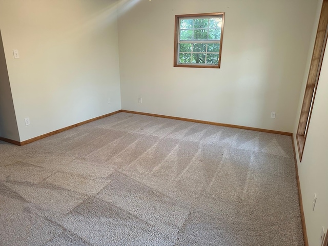 additional living space featuring vaulted ceiling and carpet