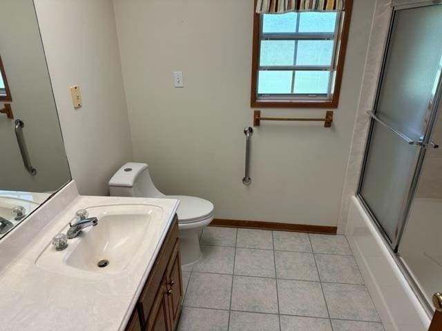 full bathroom with tile patterned flooring, vanity, toilet, and bath / shower combo with glass door