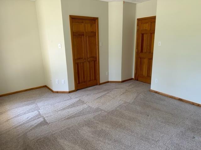 unfurnished room with light colored carpet