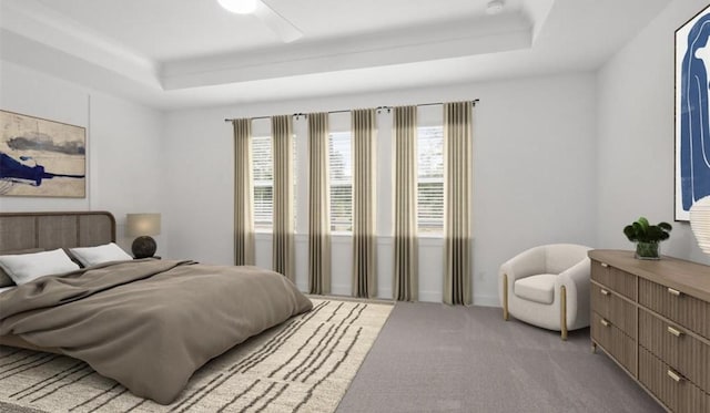 bedroom featuring ceiling fan, carpet flooring, and a raised ceiling