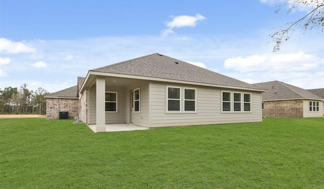 rear view of house with a yard and a patio area