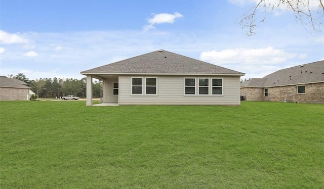 rear view of property with a yard and a patio area