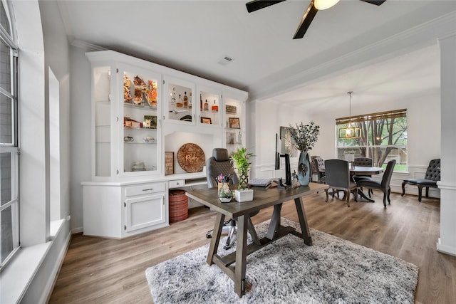 office area featuring ornamental molding, ceiling fan with notable chandelier, and light hardwood / wood-style flooring