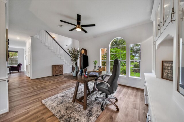 home office featuring ceiling fan and light hardwood / wood-style flooring