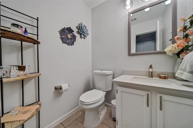 bathroom with vanity, tile patterned floors, and toilet