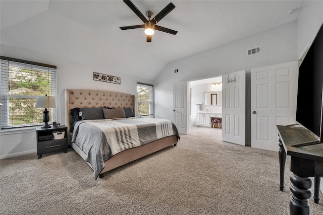 bedroom with vaulted ceiling, carpet floors, connected bathroom, and ceiling fan